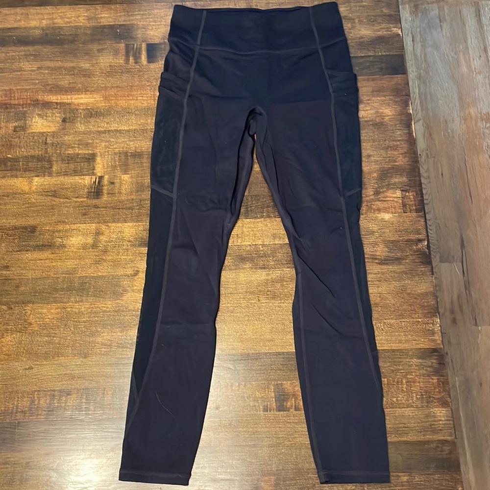 XS black fabletics leggings with mesh detailing and pockets